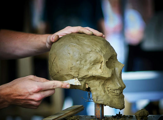 A sculptor's hands shaping clay in the studio