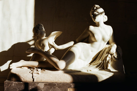 Classical marble sculpture lit by dramatic natural light
