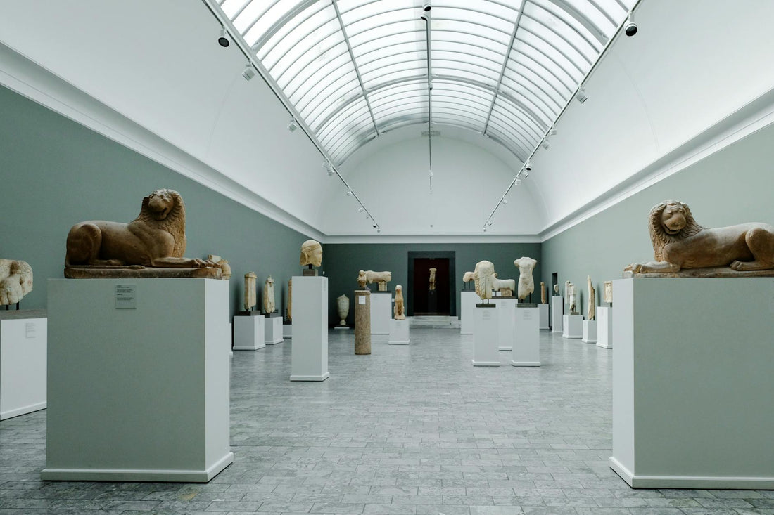 Sculptures on display in a gallery interior, viewed across an open space