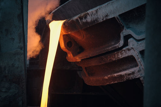 Molten bronze poured from a crucible in an art foundry