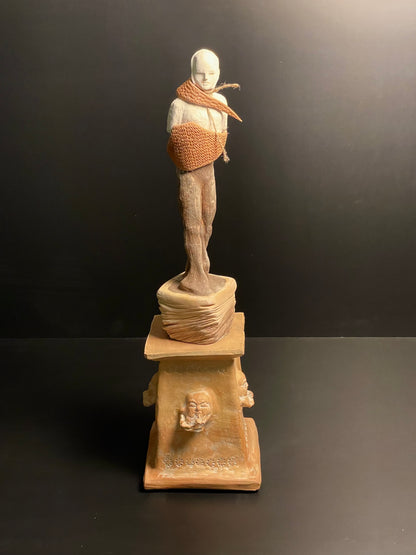 Statue on a pedestal with a dark background