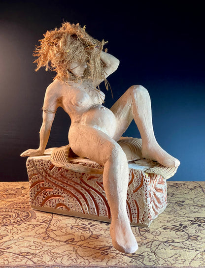 This image displays a captivating sculpture titled "Next Gen," crafted by an artist who emphasizes the intricacies of human form and the evolution of ideas. The piece is made from stoneware clay, enhanced with paint and burlap.
