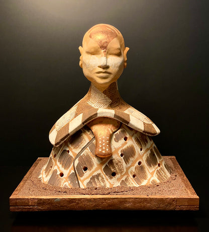 Ceramic sculpture of a figure with a textured surface on a dark background