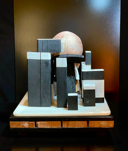 Wooden sculpture with geometric shapes on a dark background