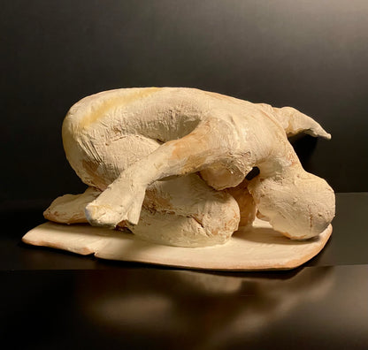 Stone sculpture of a man on a dark background