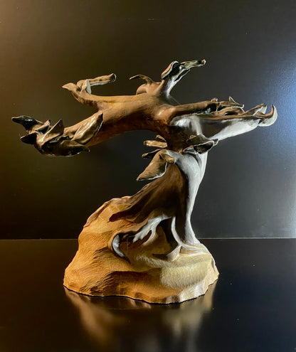 sculpture of tree on a dark background