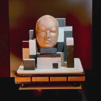 Sculpture of a human face on abstract objects