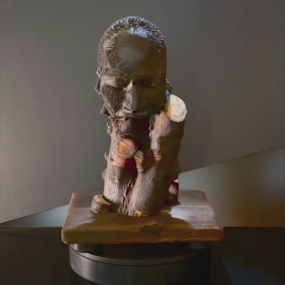 Video of a human fact on a wood base